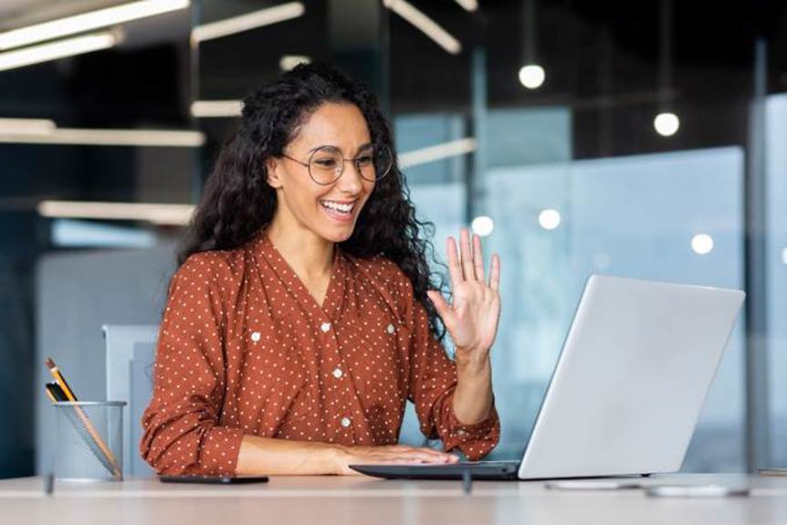 A person waving at a computer
AI-generated content may be incorrect.